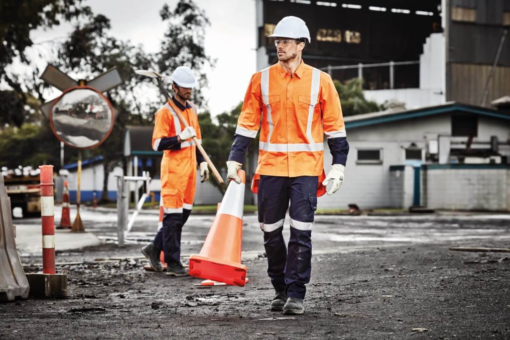 Road Workers moving holding traffic cones